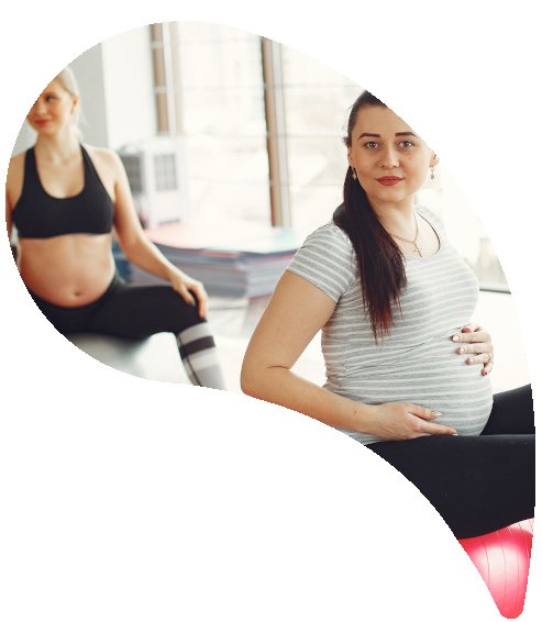 Pregnant women doing yoga in a gym